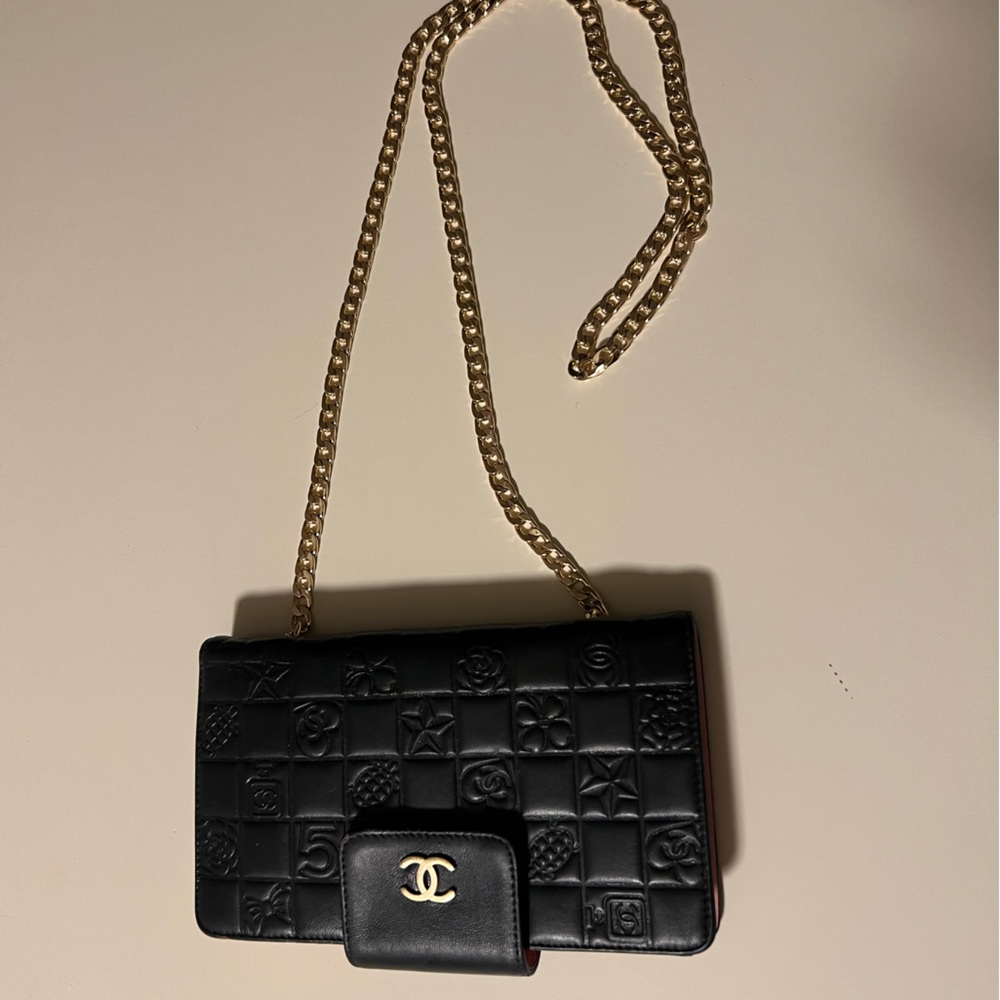 Unique, Authentic black and pink Chanel clutch with gold chain.